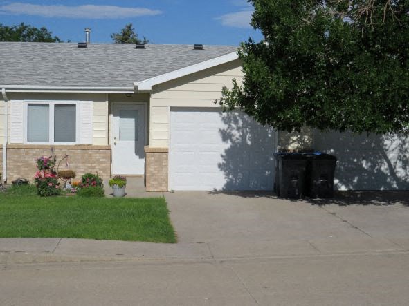 a house with a white garage door and a driveway