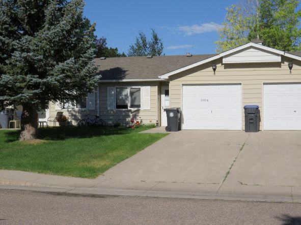 a yellow house with a white garage door