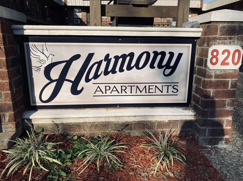 a sign in front of a building that says apartments