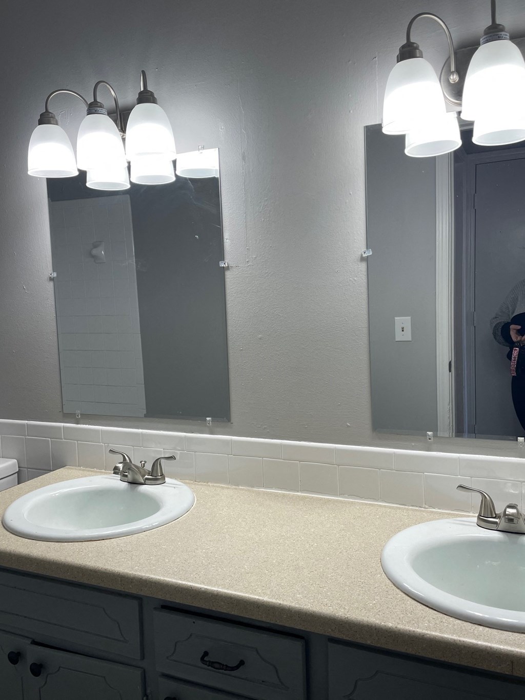 a bathroom with two sinks and a mirror