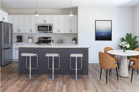 a kitchen with a blue island and a table with chairs