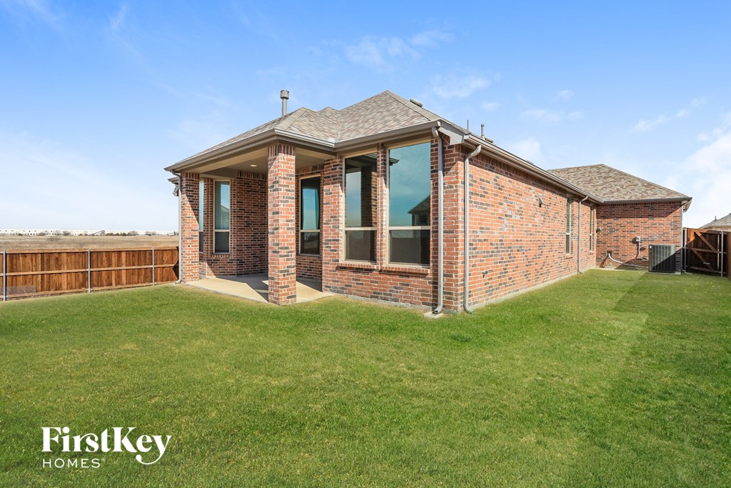 a view of the backyard of a brick house