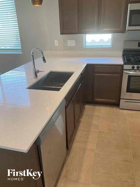 A kitchen with a sink and a stove.