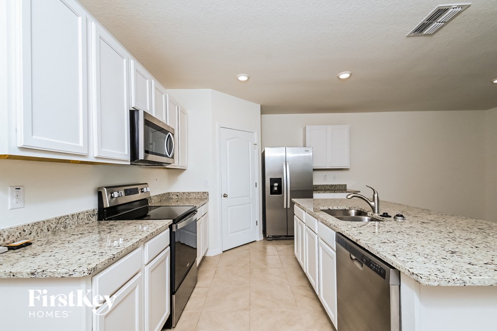 a kitchen with granite counter tops and stainless steel appliances