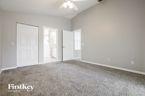 a bedroom with a carpeted floor and a white door