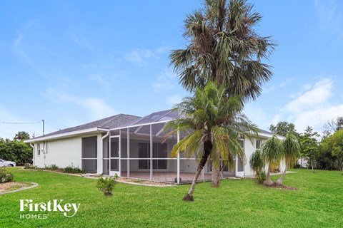 a house with palm trees in front of it