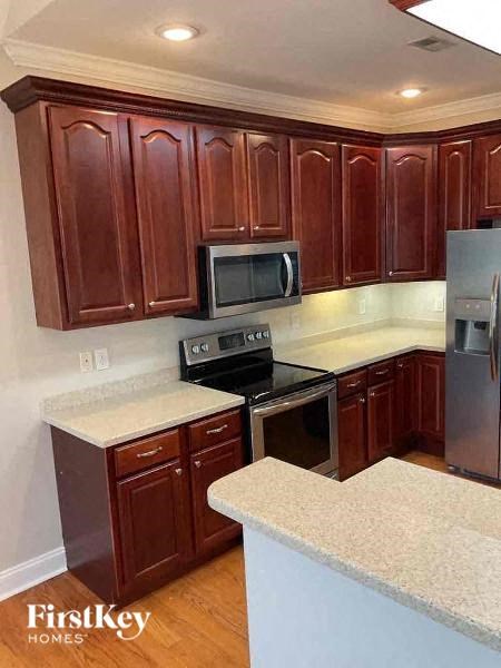 a kitchen with a stove and a refrigerator
