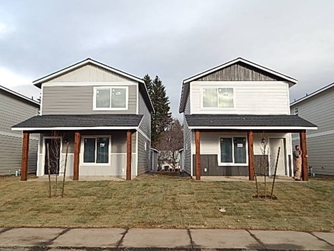 two houses on the side of a street