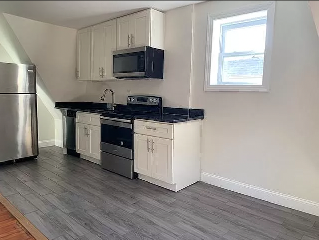 a small kitchen with a stove and a refrigerator
