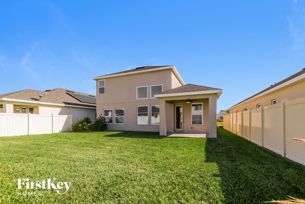a house with a lawn and a fence