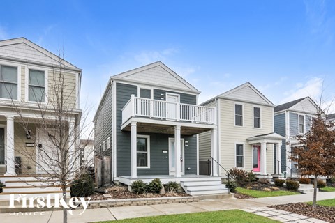 A row of houses with the first one being a light grey and the second one being a darker grey.
