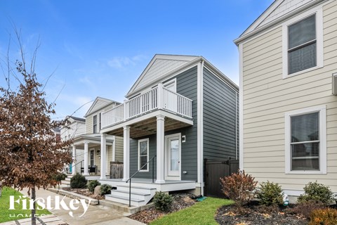 A row of houses with the first one being a light grey color.