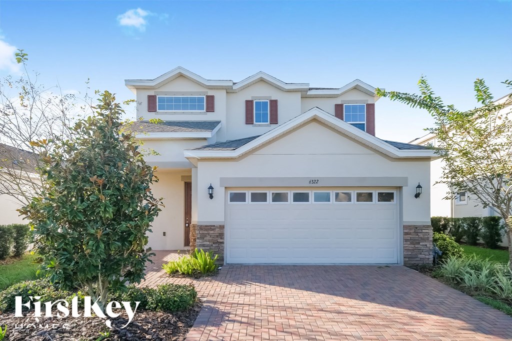 a house with a garage door in front of it