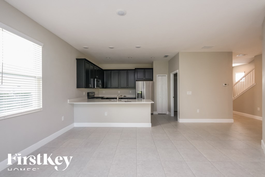 an empty kitchen and living room in a house