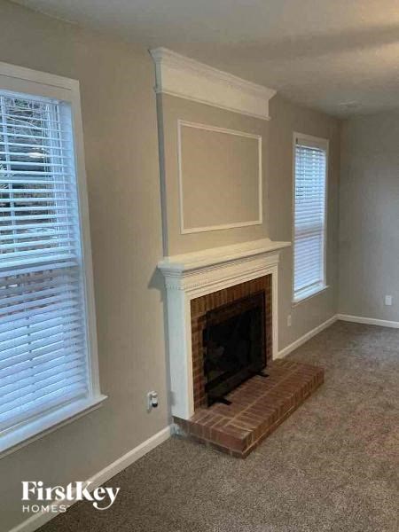 a living room with a fireplace and a window