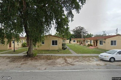 a row of houses in a street with a car