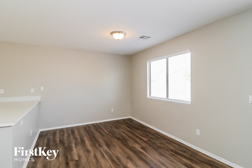 an empty room with wood flooring and a window