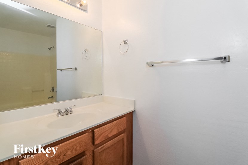 a bathroom with a white sink and a mirror