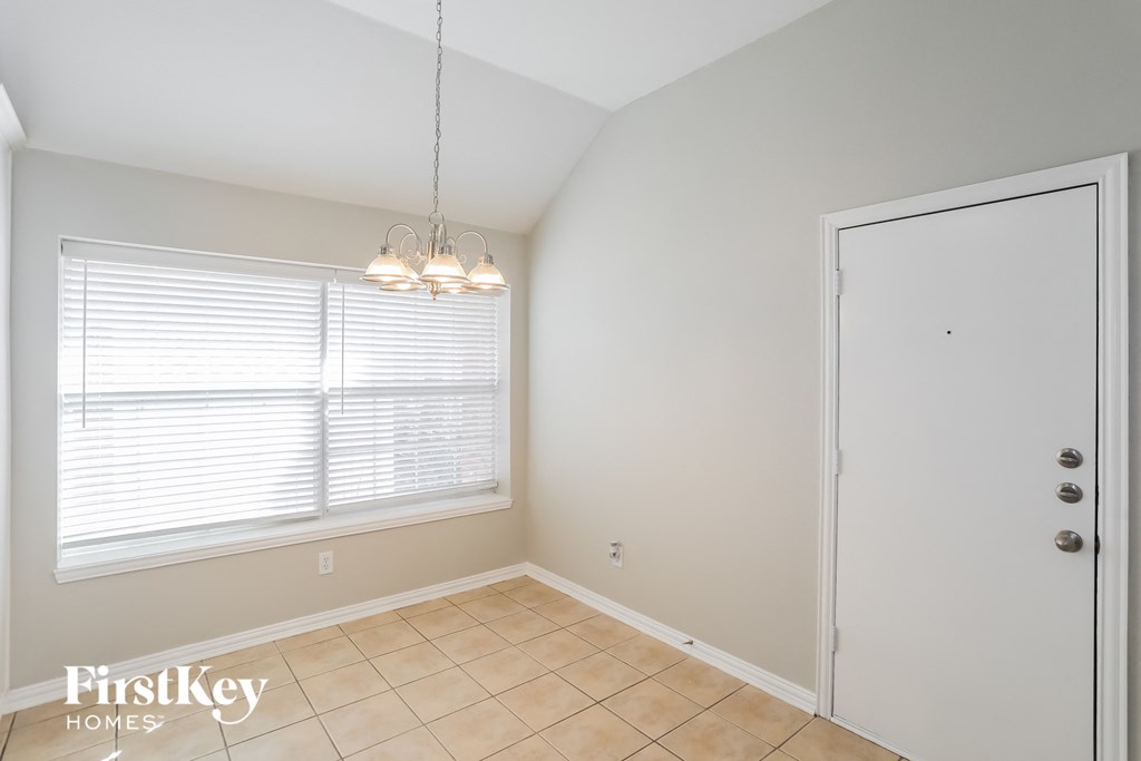 a dining room with a large window and a door to a closet