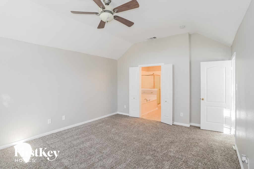 a bedroom with a carpeted floor and a ceiling fan