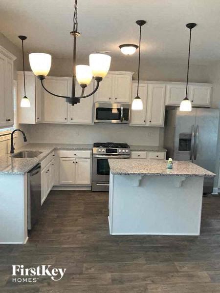 a kitchen with white cabinets and a counter top
