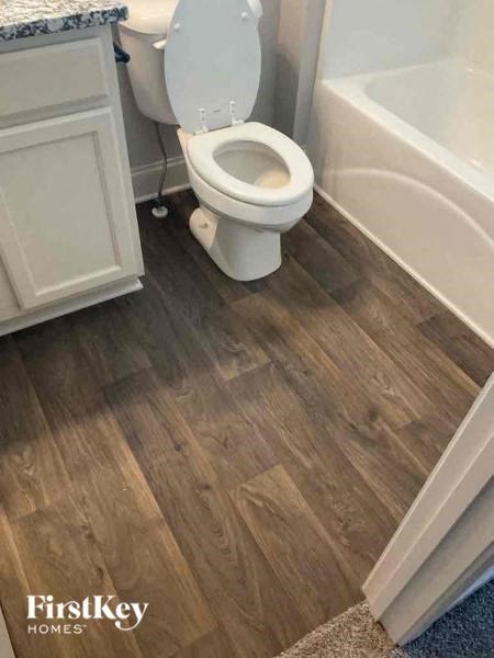 a bathroom with a toilet and a bath tub