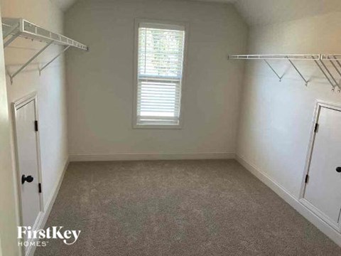 an empty room with a closet and a window