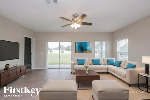 A living room with a white couch and a wooden coffee table.