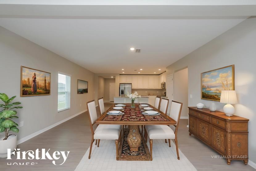 A dining room with a wooden table set for six.
