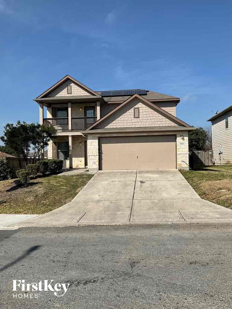 A two-story house with a garage is for sale.