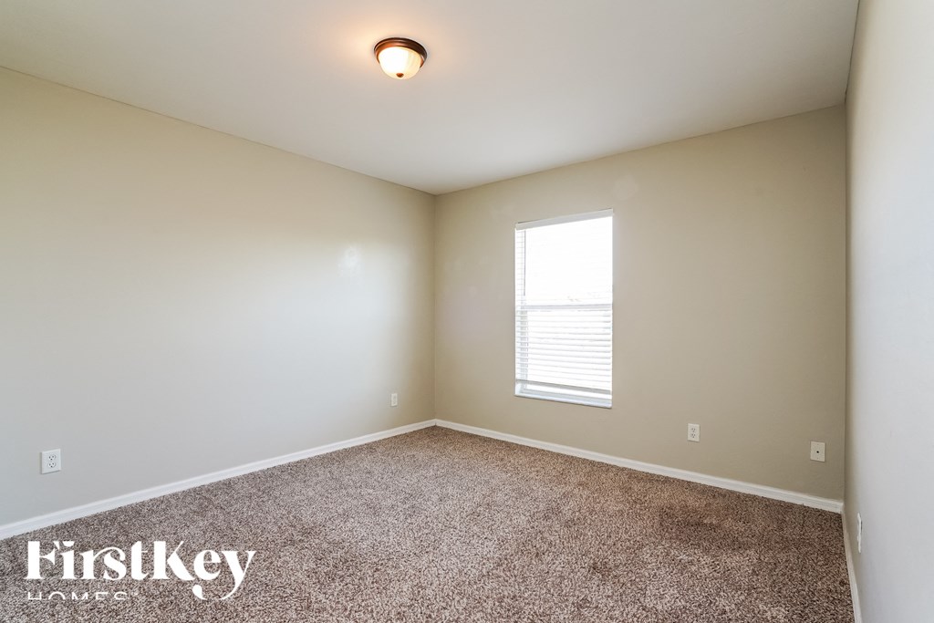 the bedroom with carpeted flooring and a window