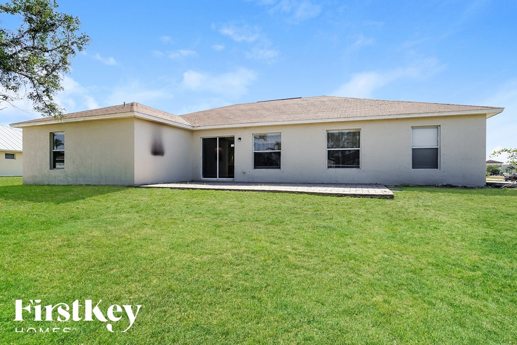 front view of a white house with a grassy yard
