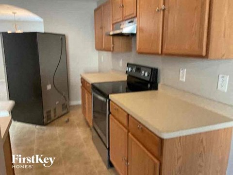 a kitchen with a stove and a refrigerator