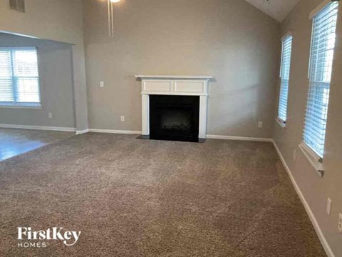 an empty living room with a fireplace