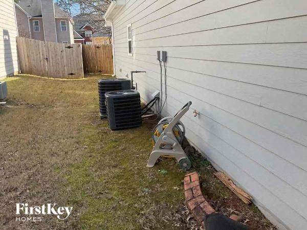 the side of a house with a tool against the wall