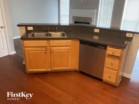 a kitchen with wooden cabinets and a sink