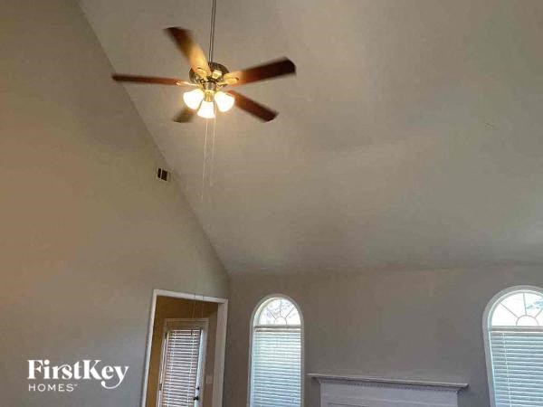a ceiling fan in a room with a window