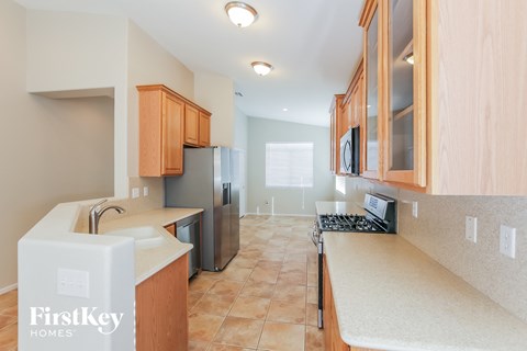 A kitchen with wooden cabinets and a white countertop.