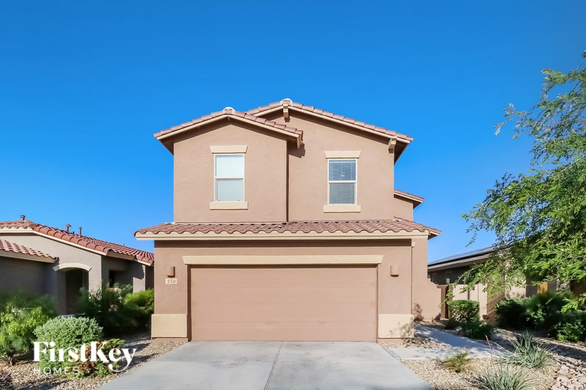 A house with a brown garage door is for sale with FirstKey Homes.