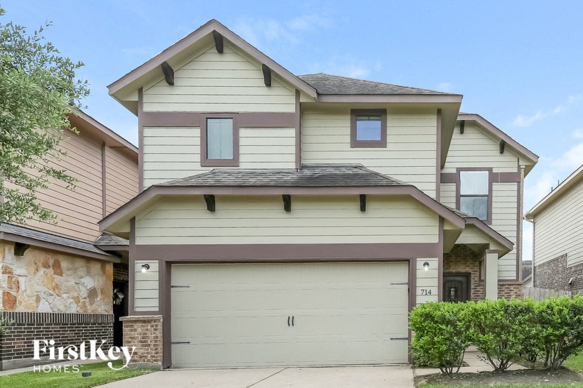 a white and brown house with a garage door
