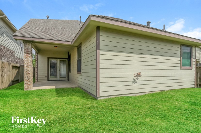 the front of a house with a green lawn and a driveway