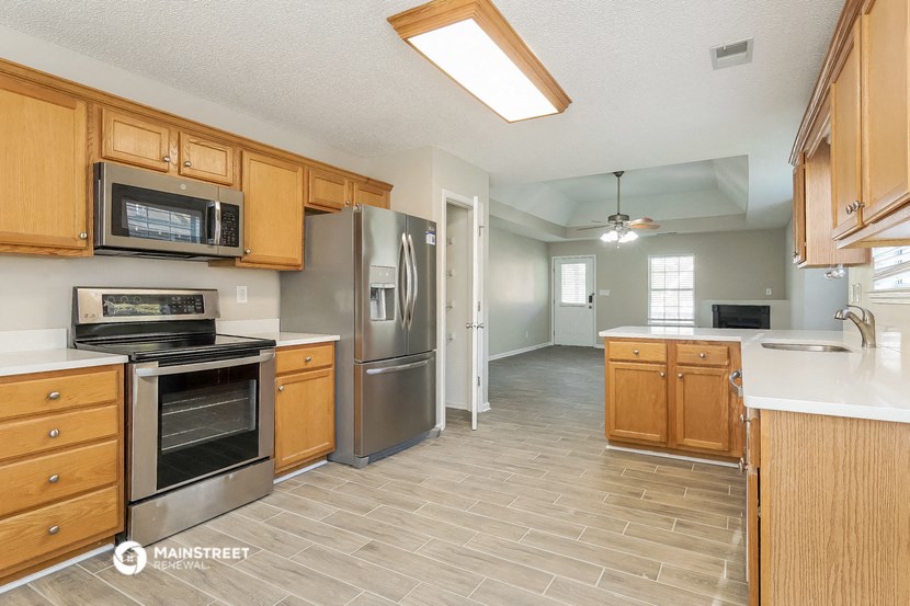 a kitchen with wooden cabinets and stainless steel appliances