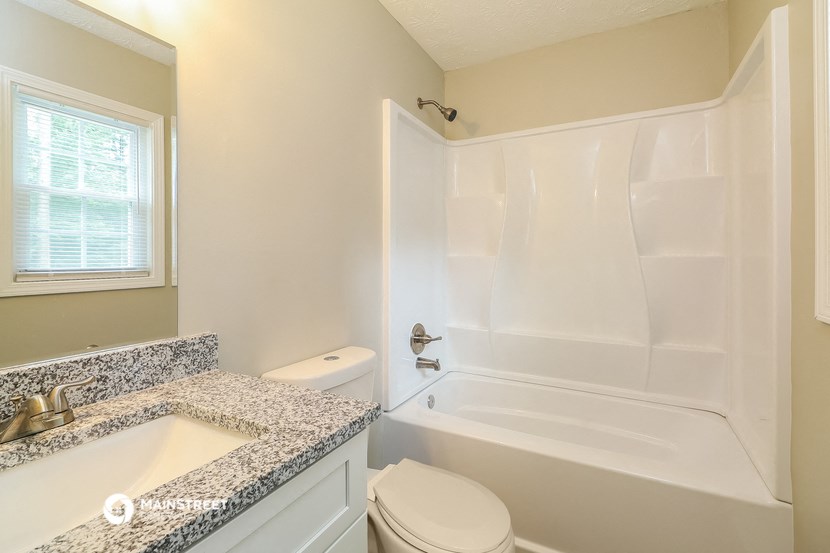 a bathroom with a sink toilet and a bath tub