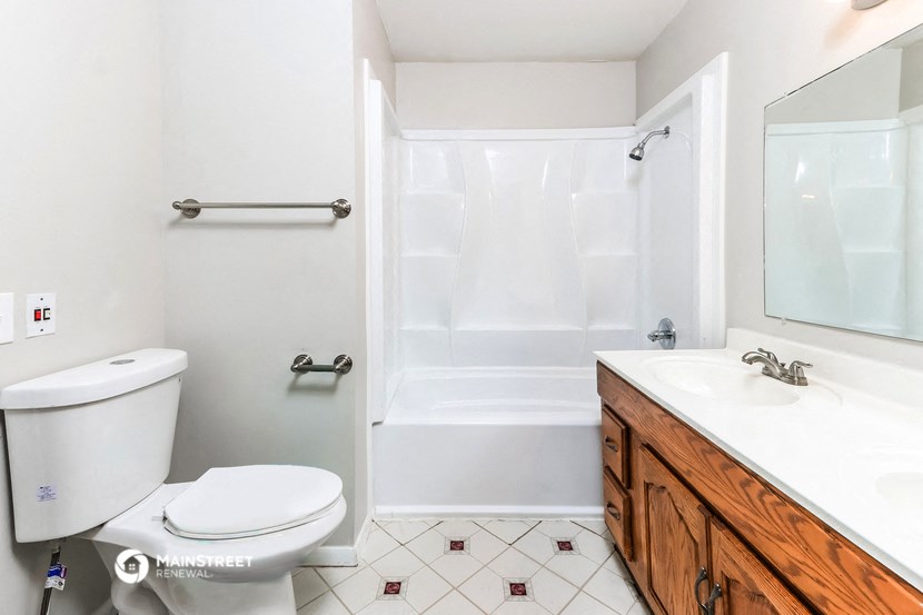 a bathroom with a toilet and a sink and a shower