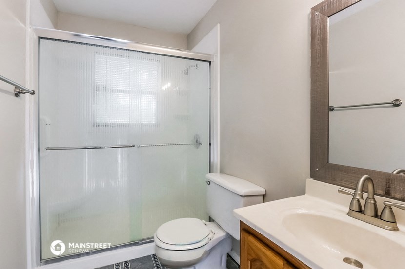 a bathroom with a shower and a sink and a toilet
