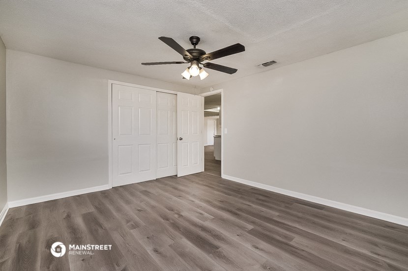 the living room of our studio apartment atrium with a ceiling fan