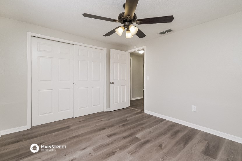the living room of our studio apartment atrium with ceiling fan and closet