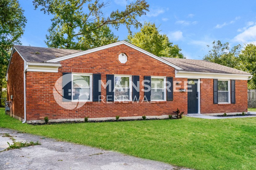 a brick house with a mural on the side of it