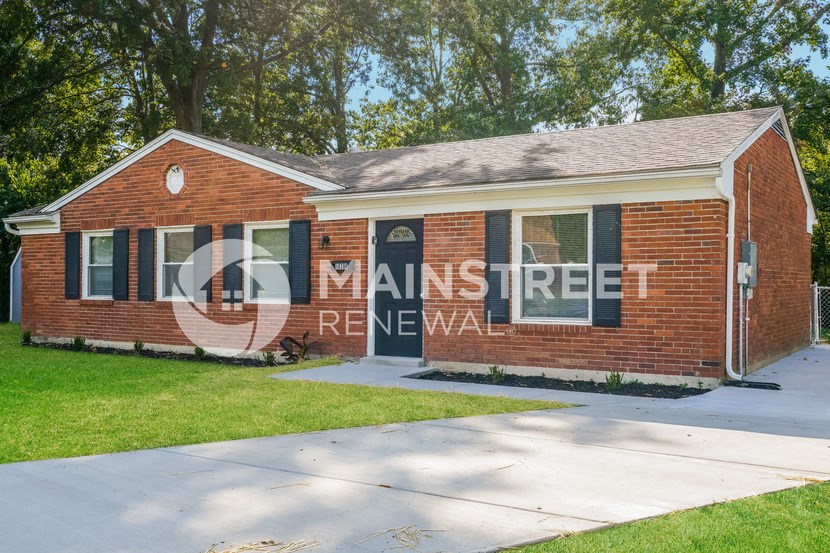 a red brick house with a sign on the side of it