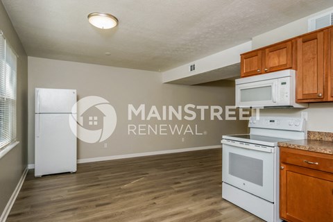 a kitchen with white appliances and wooden cabinets